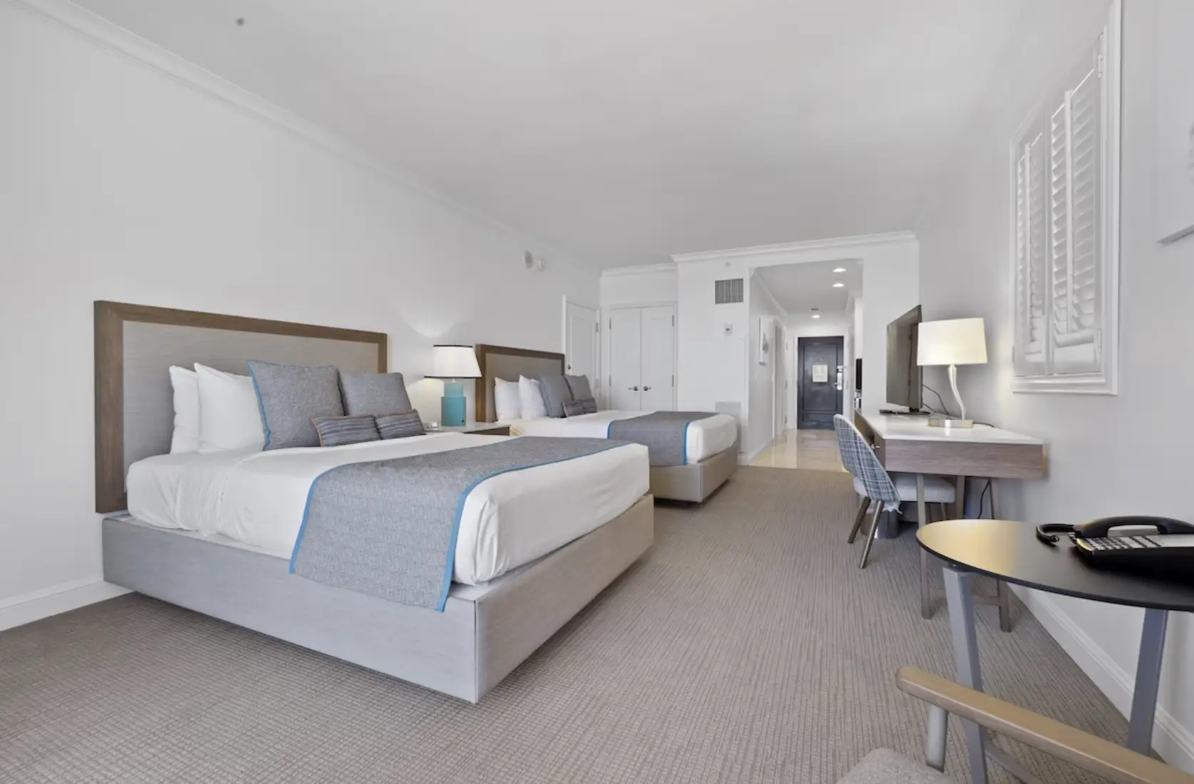 Two-bed configuration with work desk and seating area