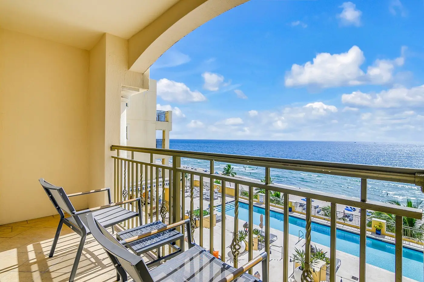 Private balcony overlooking pool and ocean