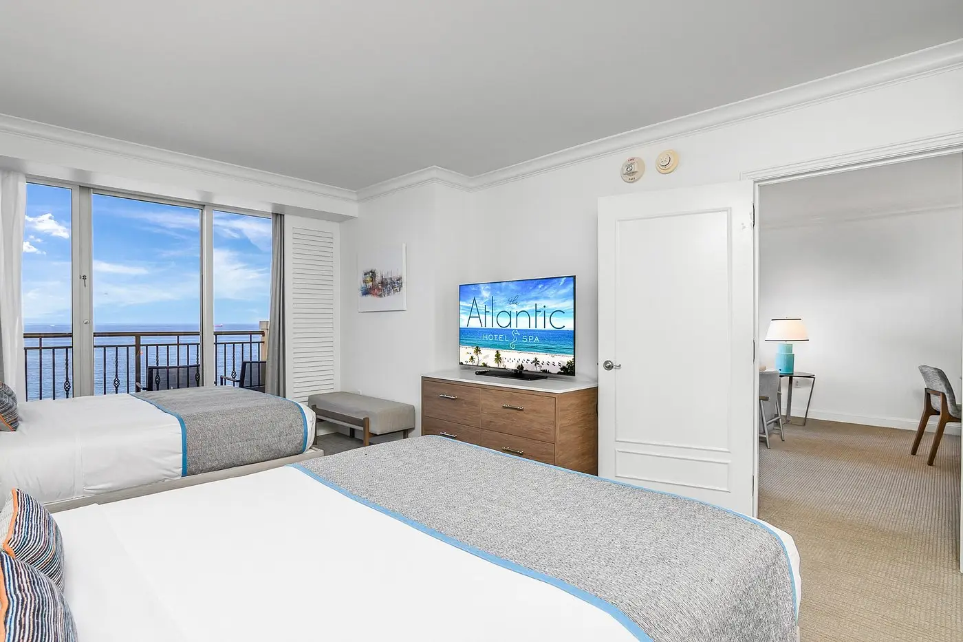 Suite bedroom with two beds and ocean view